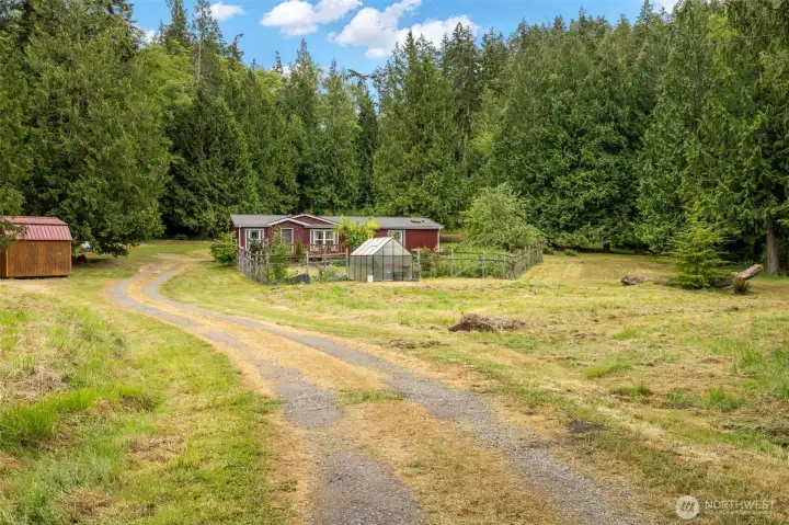 After passing the Studio/farm area, you will continue on to the main home. Continue on past there to the two level benches which are ideal homesites or additional pasture/farm land. This IS zoned Agricultural, which is a very unique zoning designation allowing for commercial uses.