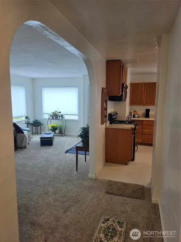 Hallway looking into living room and kitchen
