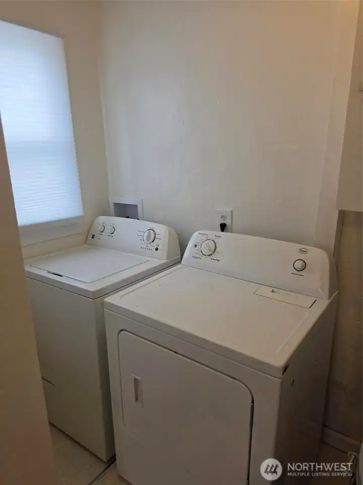 Washer/dryer off of kitchen by side door to driveway.