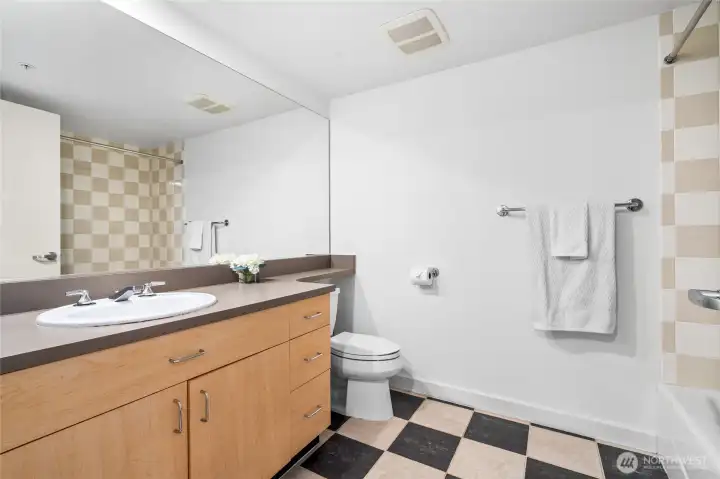 Full bath with tile floors.