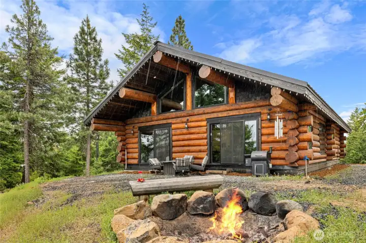 A view of the back of the cabin with the fire pit. A view of the back of the cabin with the fire pit.
