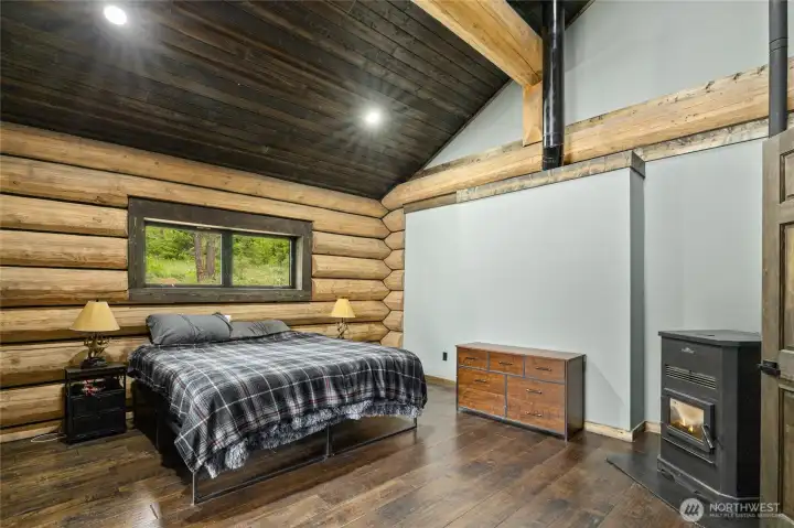 Here is the primary bedroom with a pellet stove. Here is the primary bedroom with a pellet stove.