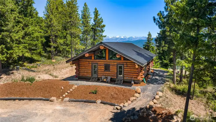 A view of the front of the cabin. Front door is just to your right in this photo. Check out the view to the Stuart Mountains. A view of the front of the cabin. Front door is just to your right in this photo. Check out the view to the Stuart Mountains.