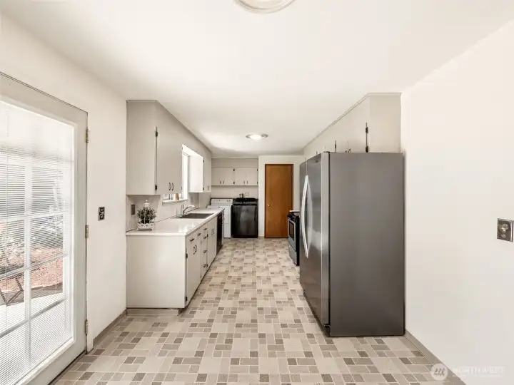 The photographer is standing in the dining area here. This would be where one would put their dining room table.
