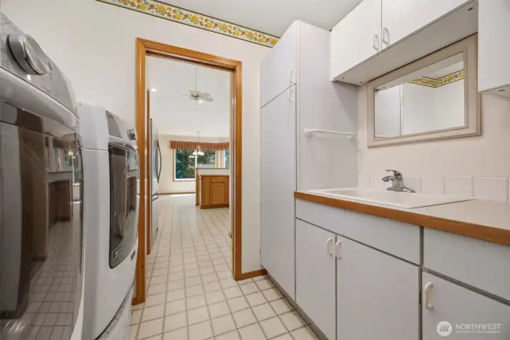 Laundry room with utility sink and plenty of storage Laundry room with utility sink and plenty of storage