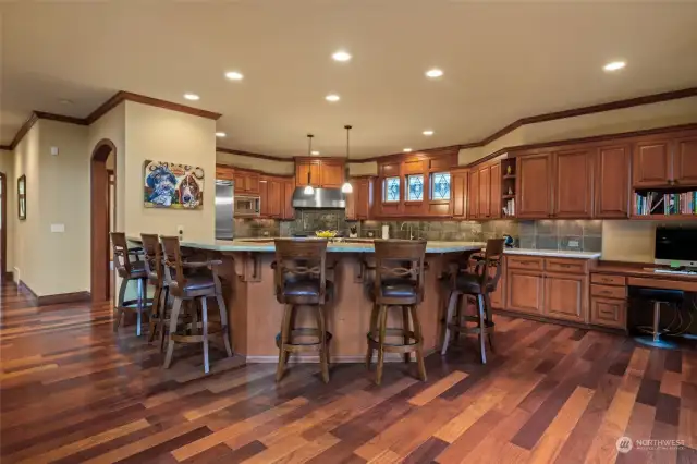 Chef's kitchen with abundance of Alder cabinets, upgraded Viking appliances, enormous eating bar and an island