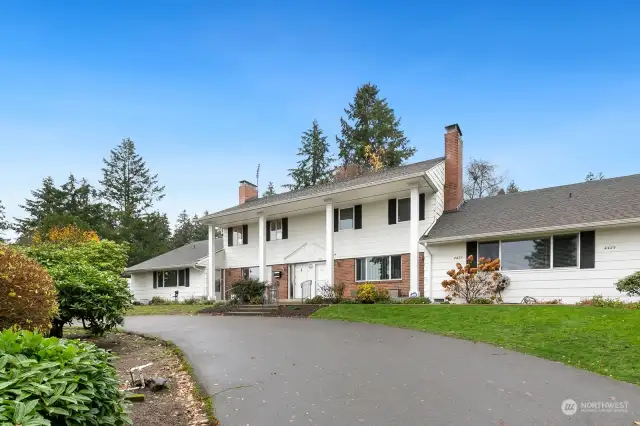 Traditional Colonial Revival architecture. Symmetry, columns, and the pediment (triangle) above the doors are all part of this style.