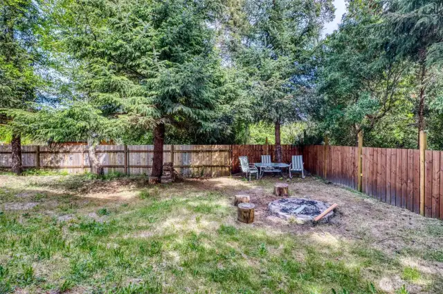 Fenced backyard with burn pit.