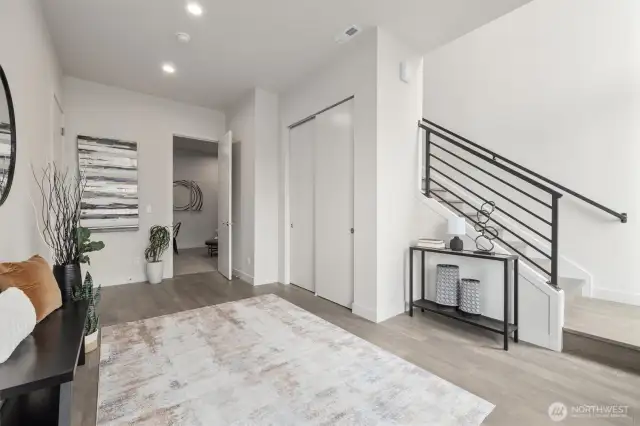 Large entryway that leads to the game room/family room/tv room and then upstairs to great room