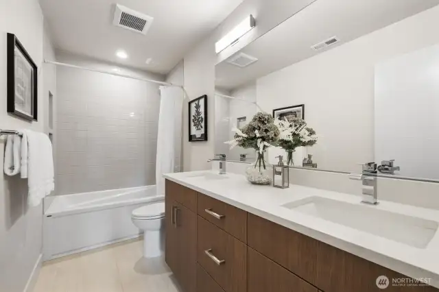 Guest bathroom on upper level with dual sinks