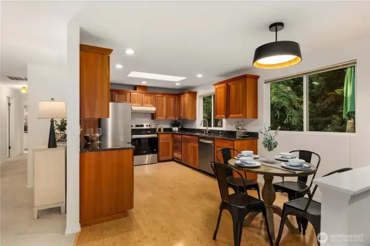 The large kitchen has gorgeous cherry cabinets and a brand new stainless steel appliance package.