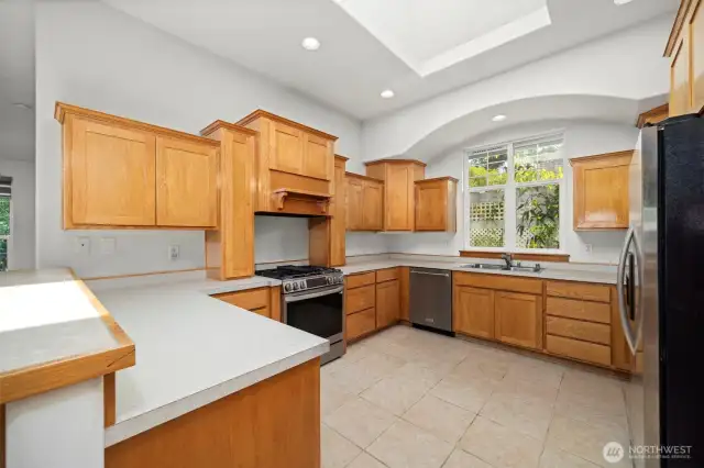 There is a stainless gas range, dishwasher and refrigerator.