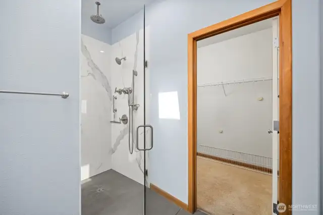 The spacious walk-in closet is next to the roll-in shower.