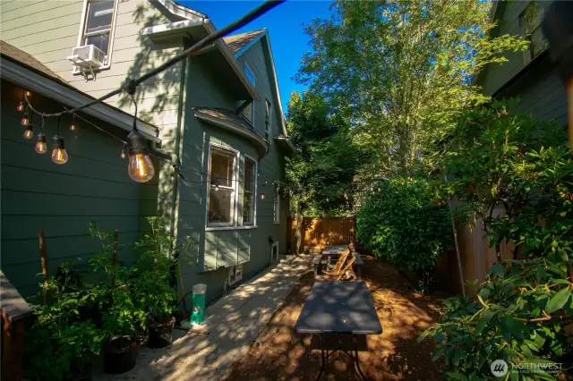 Enclosed side yard with picnic table perfect for entertaining.