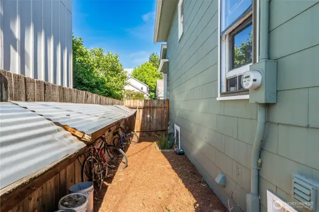 Enclosed side of house has bike storage for students.