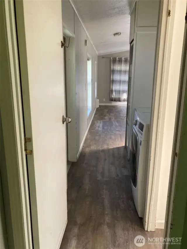 View from bedroom down hall to living