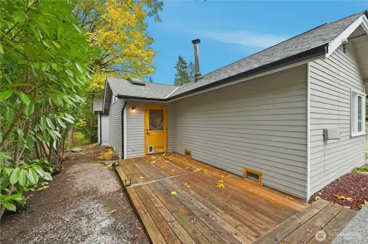 Back deck with door leading to kitchen.