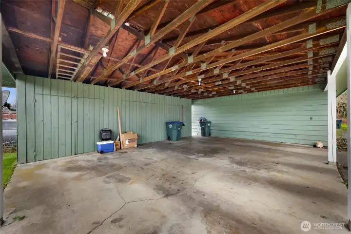 3 bay carport with individual storage attached to the duplex units.