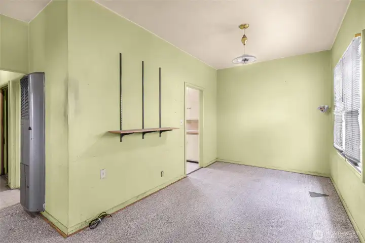 Hallway to bathroom & bedroom on left, dining area off kitchen to the right