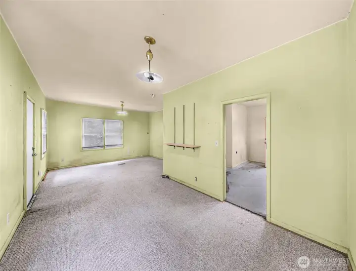 From the dining area looking towards the front door on the left, living room center & kitchen doorway on right