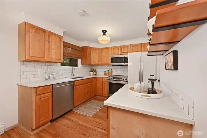 Kitchen with quartz counters, and newer appliances.