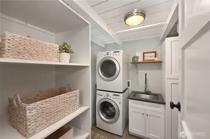 Efficient laundry room with utility sink.