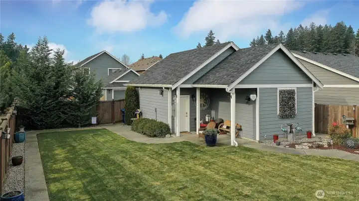 The detached garage is a standout feature, offering generous space and flexibility while enhancing the home’s layout. Positioned on a corner lot, the house and garage work together to gently cradle the expansive backyard, creating a private, enclosed feel that’s rarely found. The result is a yard that feels intentionally designed—ideal for entertaining, play, pets, or simply enjoying a sense of relaxation. The garage’s placement adds both function and charm, framing the outdoor space and elevating the overall sense of privacy and flow.