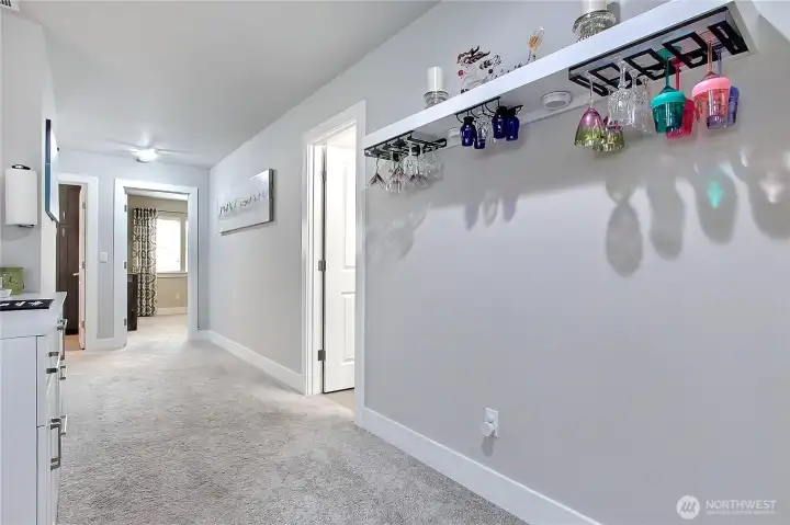 Looking down the wide upstairs hallway, you’ll notice an attached dry bar area—perfect for snacks, beverages, or entertaining. This thoughtful addition adds convenience and a touch of luxury to everyday living.