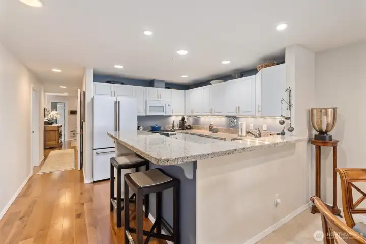 The home welcomes you with a rich hardwood entry that extends down the hallway and into the updated kitchen, creating a seamless and elegant flow. Just imagine friends and loved ones gathered around the kitchen during holidays and special occasions, sharing laughter, meals, and memories in this inviting space.