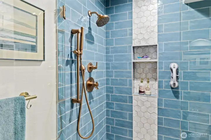 The updated 5-piece primary bath exudes a spa-like ambiance, offering the perfect place to unwind, refresh, and start or end your day in total relaxation.