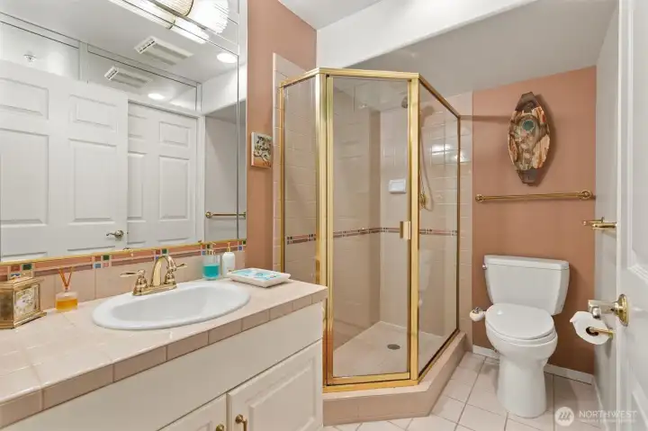 The guest bath conveniently connects to both the guest room and the hallway, offering easy access for residents and visitors alike.