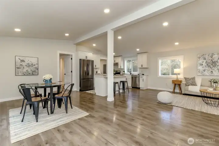 This view of the kitchen and dining room was taken from the front door. Primary bedroom to the left of the fridge.