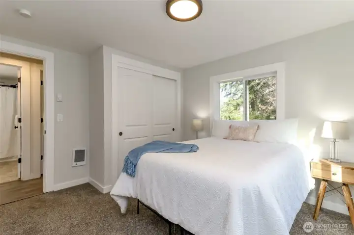 This bedroom is on the other end of the house from the primary bedroom. Through the doorway is the full bathroom across from it.