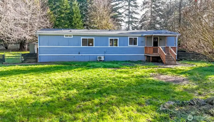 Backyard  with green outbuilding to the left of this photo.
