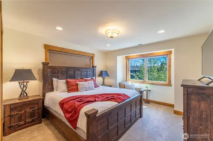 A beautifully appointed, light-filled primary king suite offering a bright and inviting retreat.