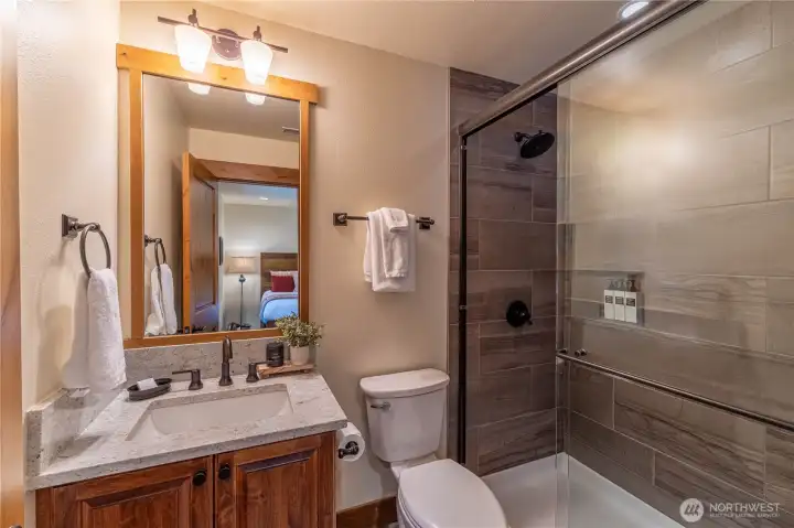 Well-appointed en suite bathroom featuring stylish design and quality finishes.