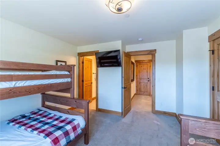 Versatile bunkroom with two full beds and two twin beds, offering comfortable accommodations for all ages
