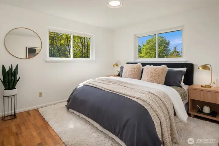 The primary bedroom on the main floor easily handles this king sized bed and is one of three main floor bedrooms.