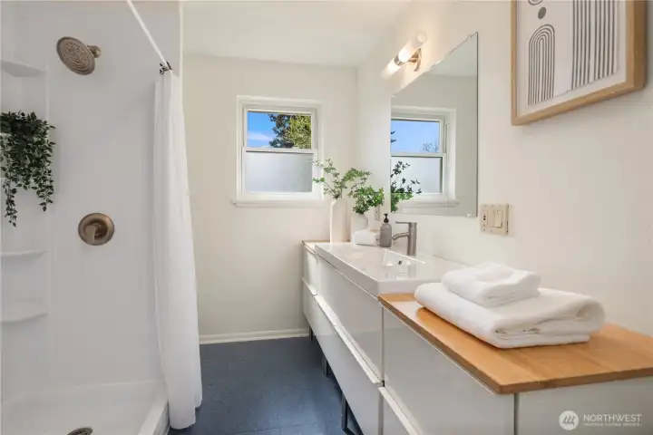 The oversized main floor bathroom features a triple vanity for great storage as well as a large walk-in shower.