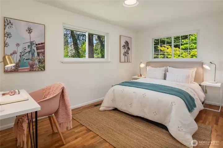 The second of three bedrooms on the main floor. This is the front corner bedroom with a lighted desk area on the left.