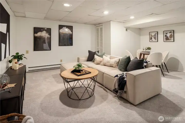 Just downstairs is this spacious rec room with new paint and new carpet.