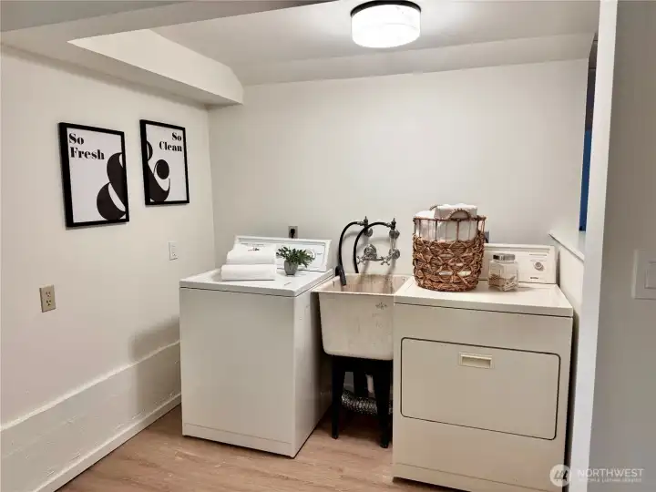 The full sized laundry area has new paint and LVP flooring.
