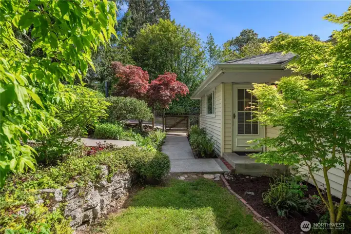 The sidewalk leads to the driveway and 2 car garage with the one on the left leading up to the ample parking area along 21st.