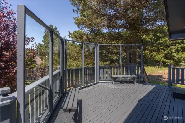 The side deck overlooking the garden includes glass wind break panels, so the deck can be pleasantly enjoyed even on a windy day!
