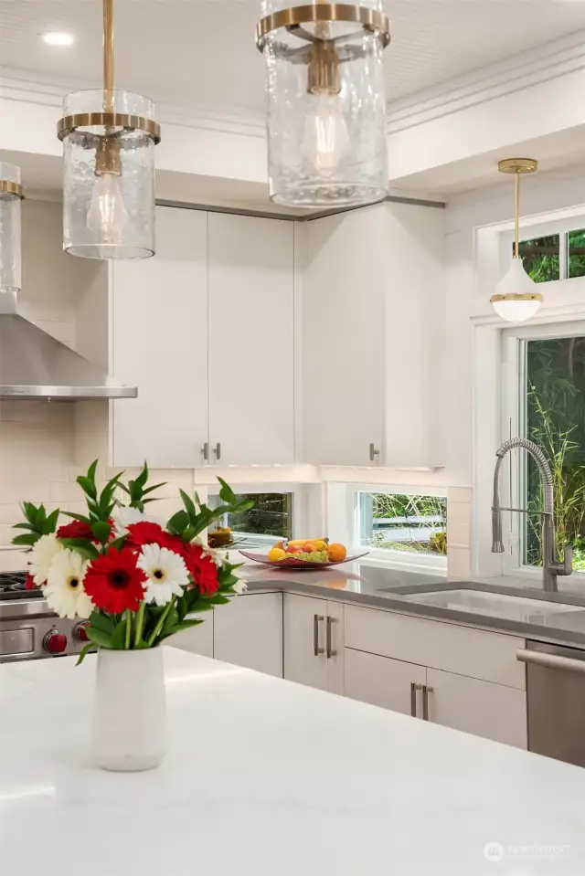 Quartz counters, high end appliances and fixtures, abundant cabinetry and storage.