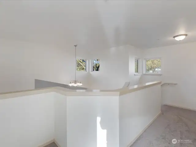 Second story balcony w/ hallway leading to two beds and full bath.