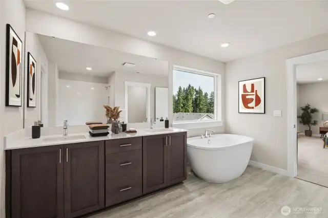 Primary bedroom 5-piece bathroom with freestanding soaker tub. Photo of actual home with virtual staging.