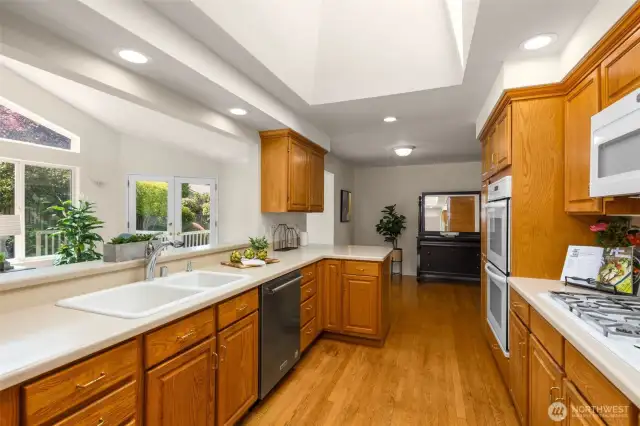 Kitchen overlooks cozy family room w/ windows!