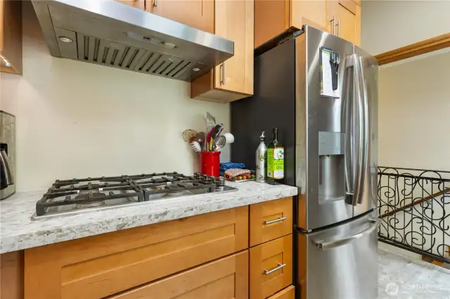 Beautiful gas range cook top with ss hood and ss appliances to enjoy in this updated kitchen