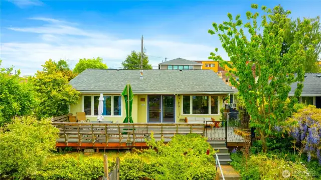 Front view of this updated view home with tranquil greenbelt and city view—peaceful and picturesque settings to enjoy from your trex deck year around.  There is Seattle skline and waterfront views from roof top also